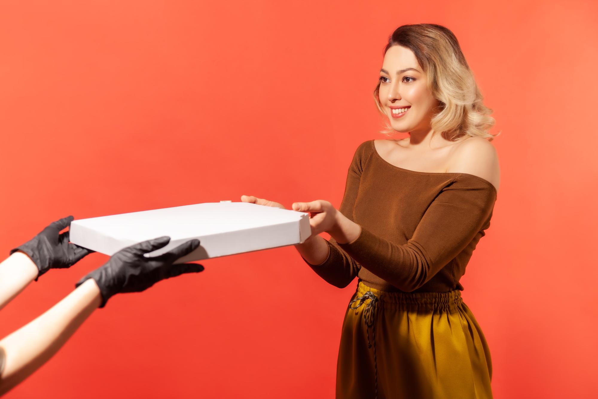 Chef handing over a boxed meal