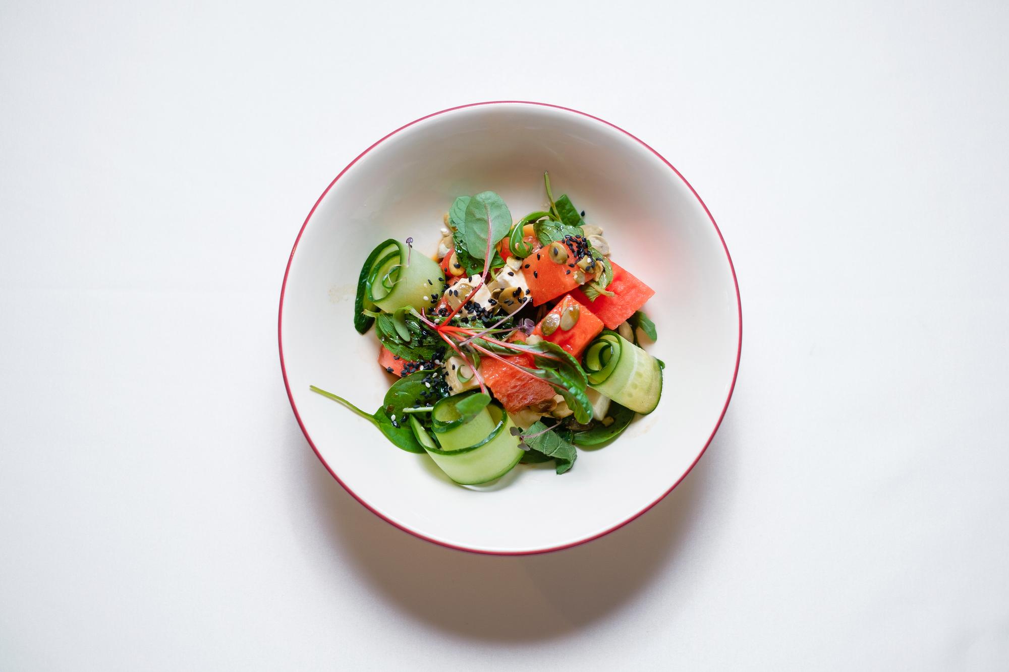 Plated seasonal salad in ceramic bowl